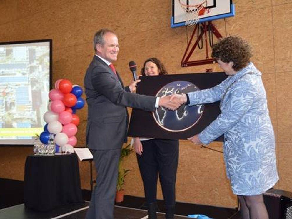 Burgemeester Kompier ontvangt een foto van het gevenornament. Foto: Pieter Kolff, bedrijfsjournalist COA.