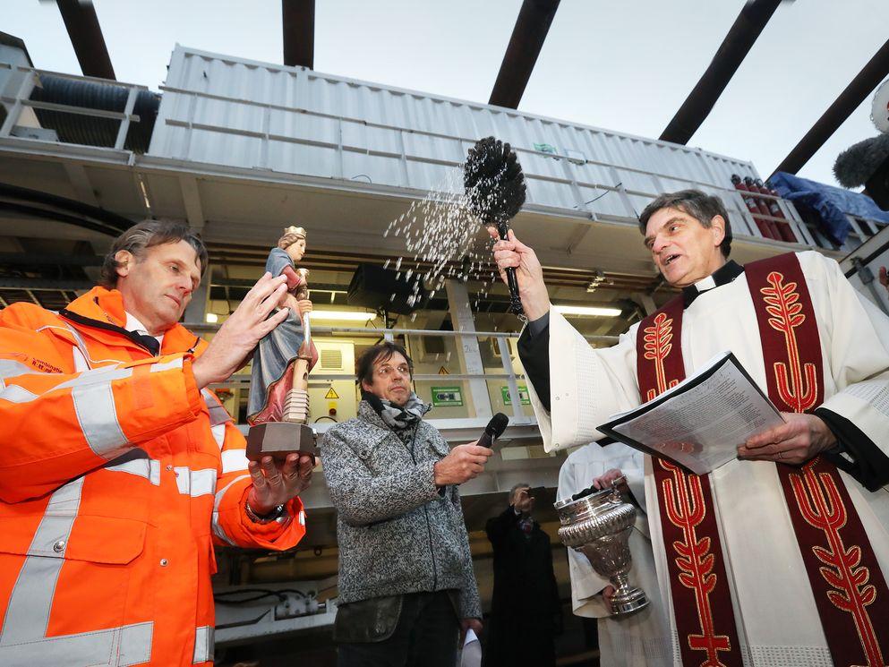 Priester Van der Helm zegent het beeldje van de Heilige Barbara. Foto Frank Jansen