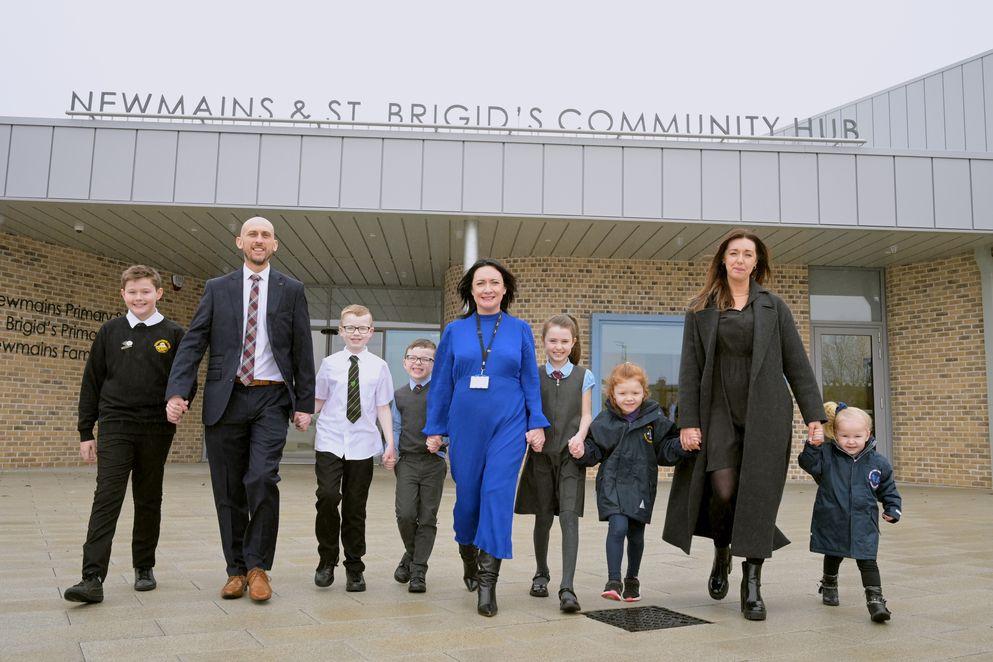 Pupils and adults in front of the community hub